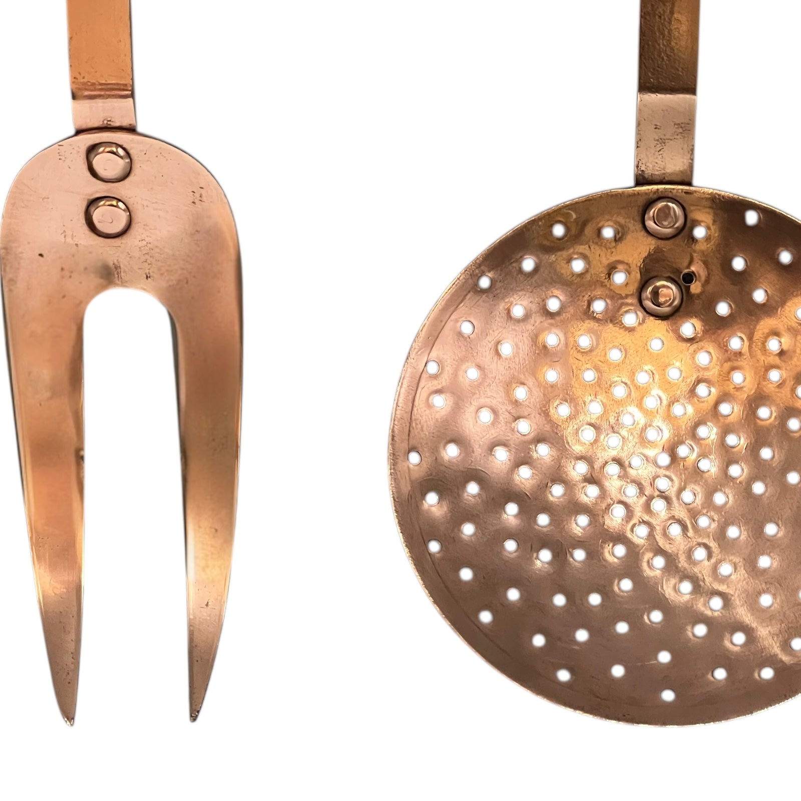 Copper kitchen utensils including a ladle and fork on a white background