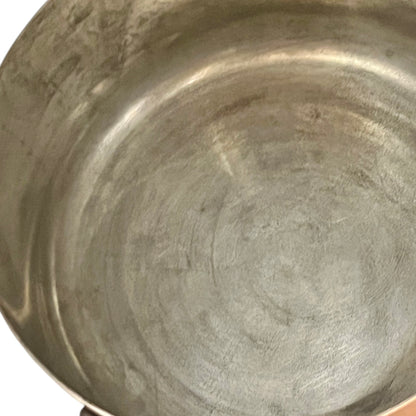 Close-up of copper cookware with iron handles on a white background