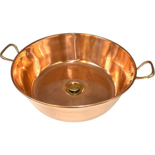 Copper basin sink with brass handles and a brass waste on a white background