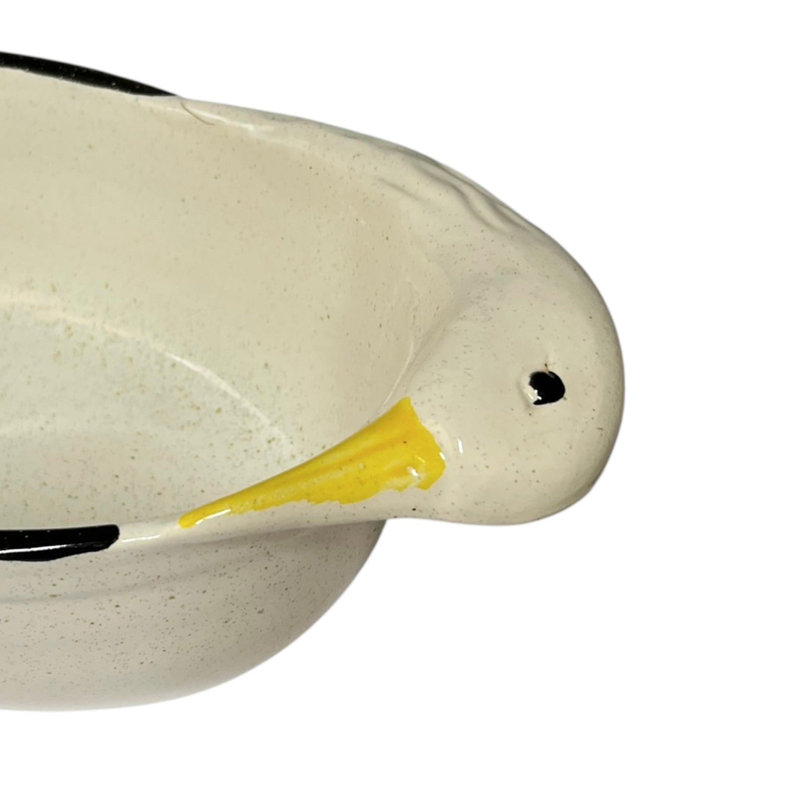 Close-up of a ceramic duck dish  with a yellow beak on a white background