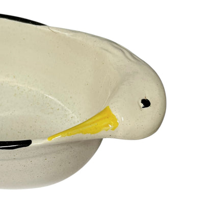 Close-up of a ceramic duck dish  with a yellow beak on a white background