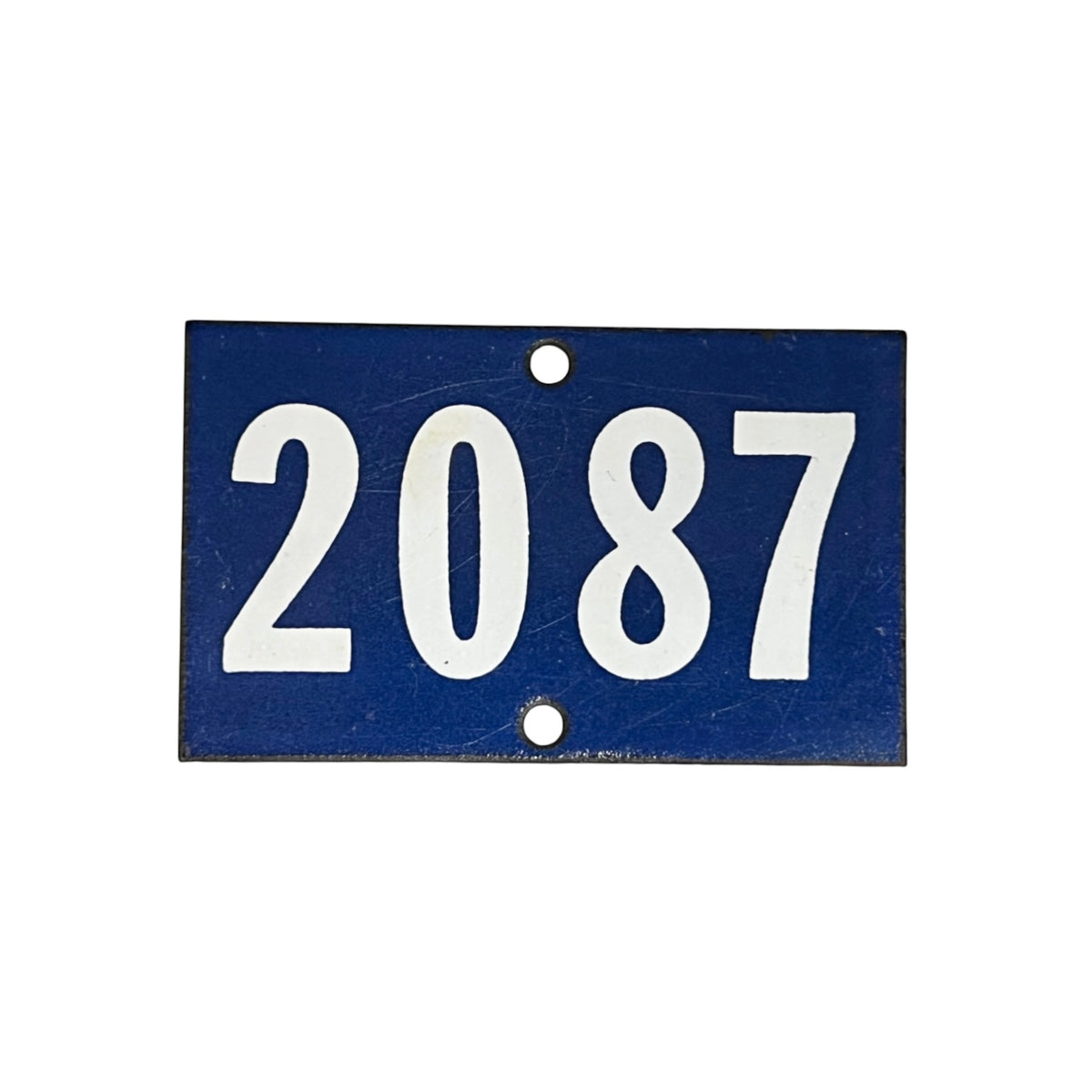 A rectangular blue house number plaque with the white numbers '2087' and two mounting holes, shown on a plain white background.