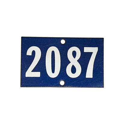 A rectangular blue house number plaque with the white numbers '2087' and two mounting holes, shown on a plain white background.