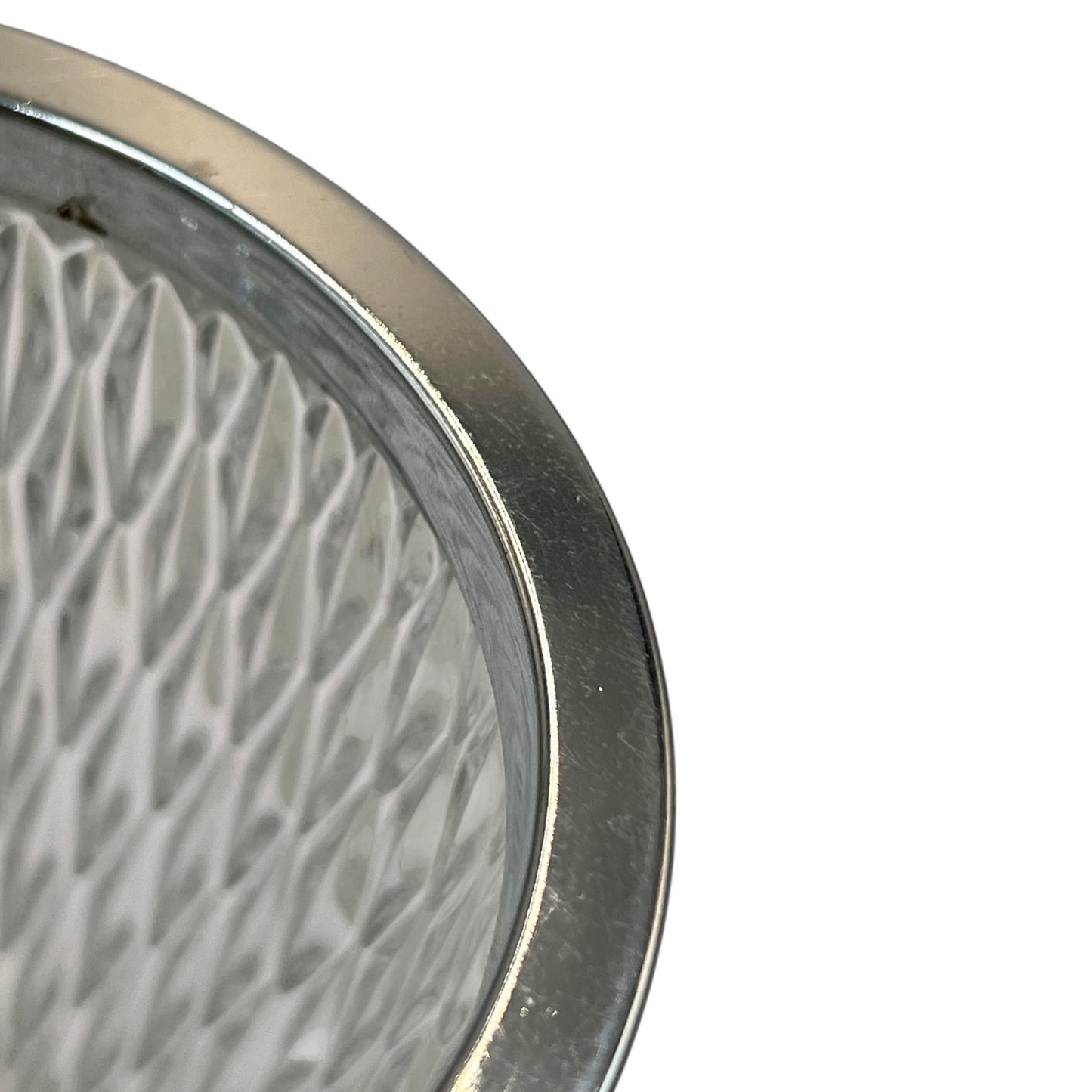 Close up of a French vintage glass ice bucket with a silver coloured collar and a handle on a white background 