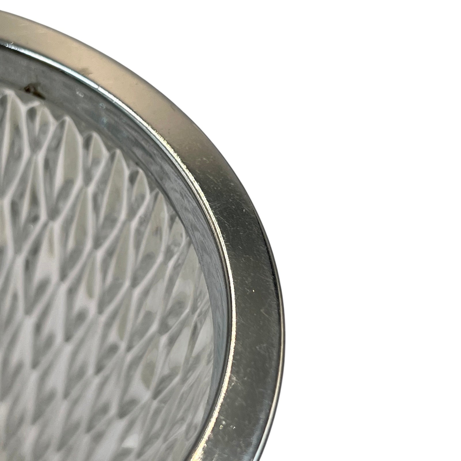 Close up of a French vintage glass ice bucket with a silver coloured collar and a handle on a white background 