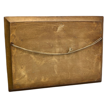 back view of wooden relief sculpture in an arts and crafts style on a white background