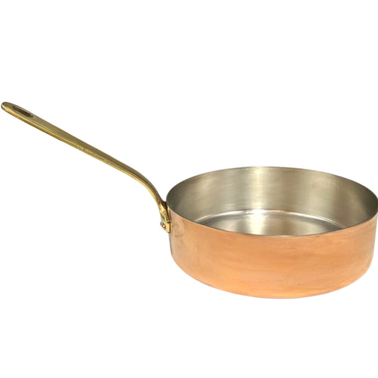 Copper frying pan with a gold handle on a white background