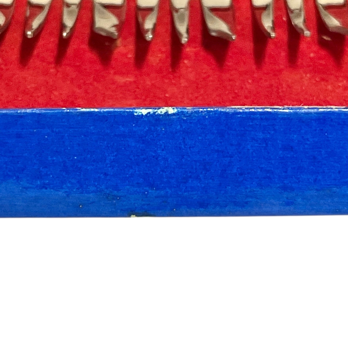 Close-up of a red and blue box containing 12 French dessert forks on a white background