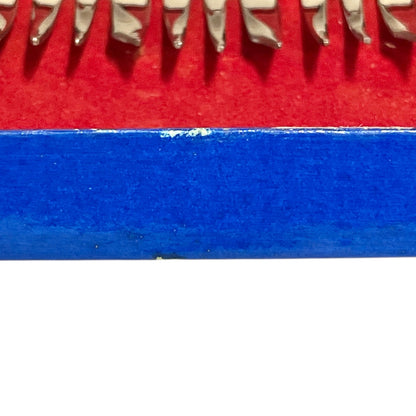 Close-up of a red and blue box containing 12 French dessert forks on a white background