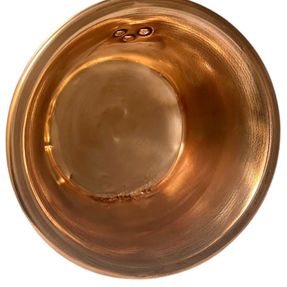 Close up of French vintage copper ladle pan with a black handle on a white background