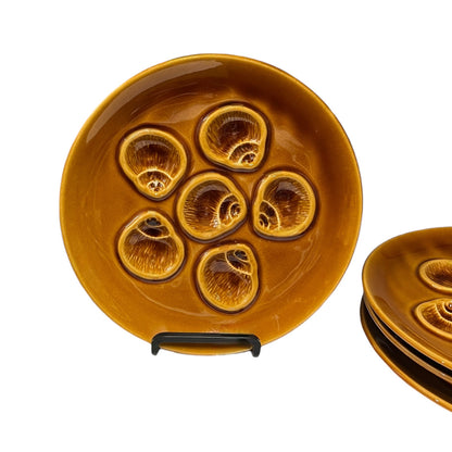 Set of ceramic plates with a brown glaze on a white background
