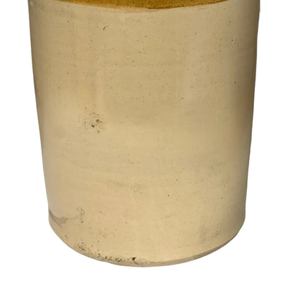 Close up of a beige cylindrical WW1 jar on a white background