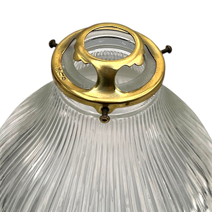 Clear glass pendant light with brass fitting on a white background