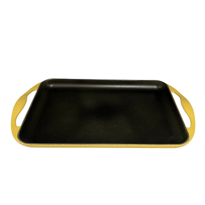 Le Cresuet flat griddle pan with yellow handles on a white background