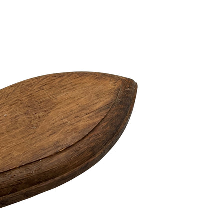 Close up of taxidermy deer hooves on a wooden mount on a white background