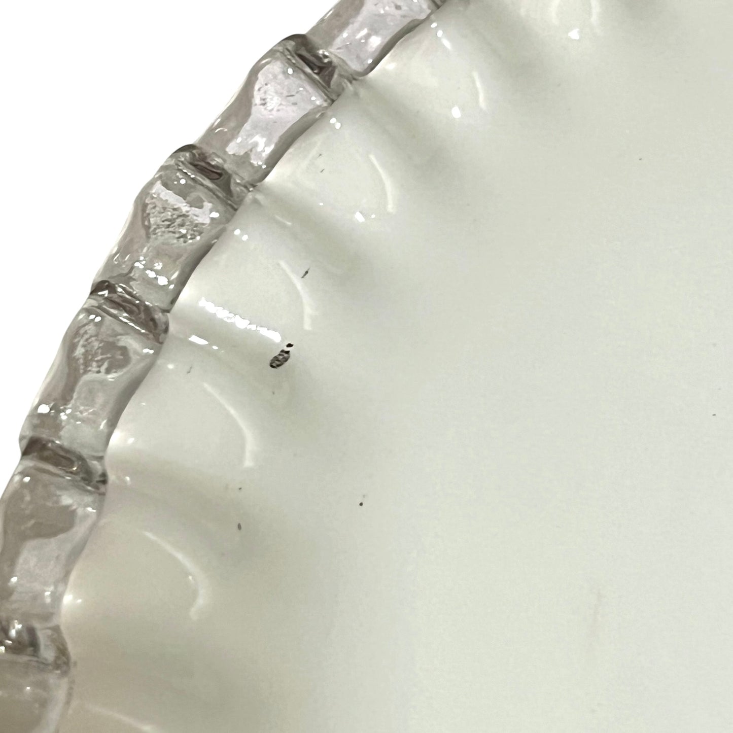 close up of white glass lampshade with a pie crust edge