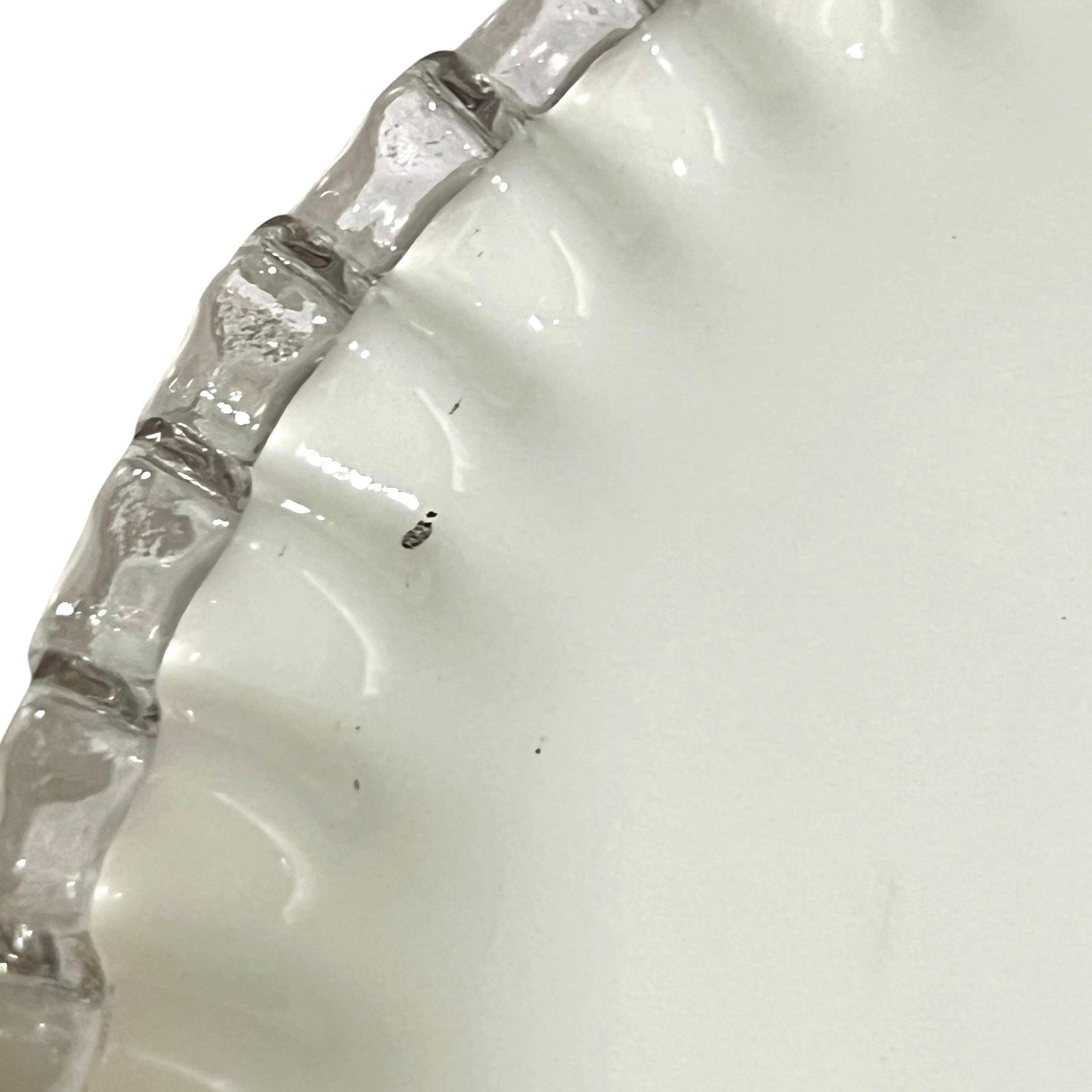 close up of white glass lampshade with a pie crust edge