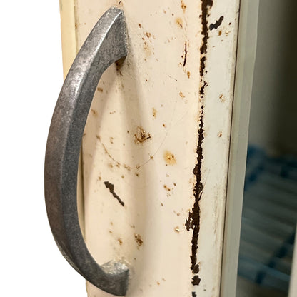 close up of a vintage metal bathroom cabinet