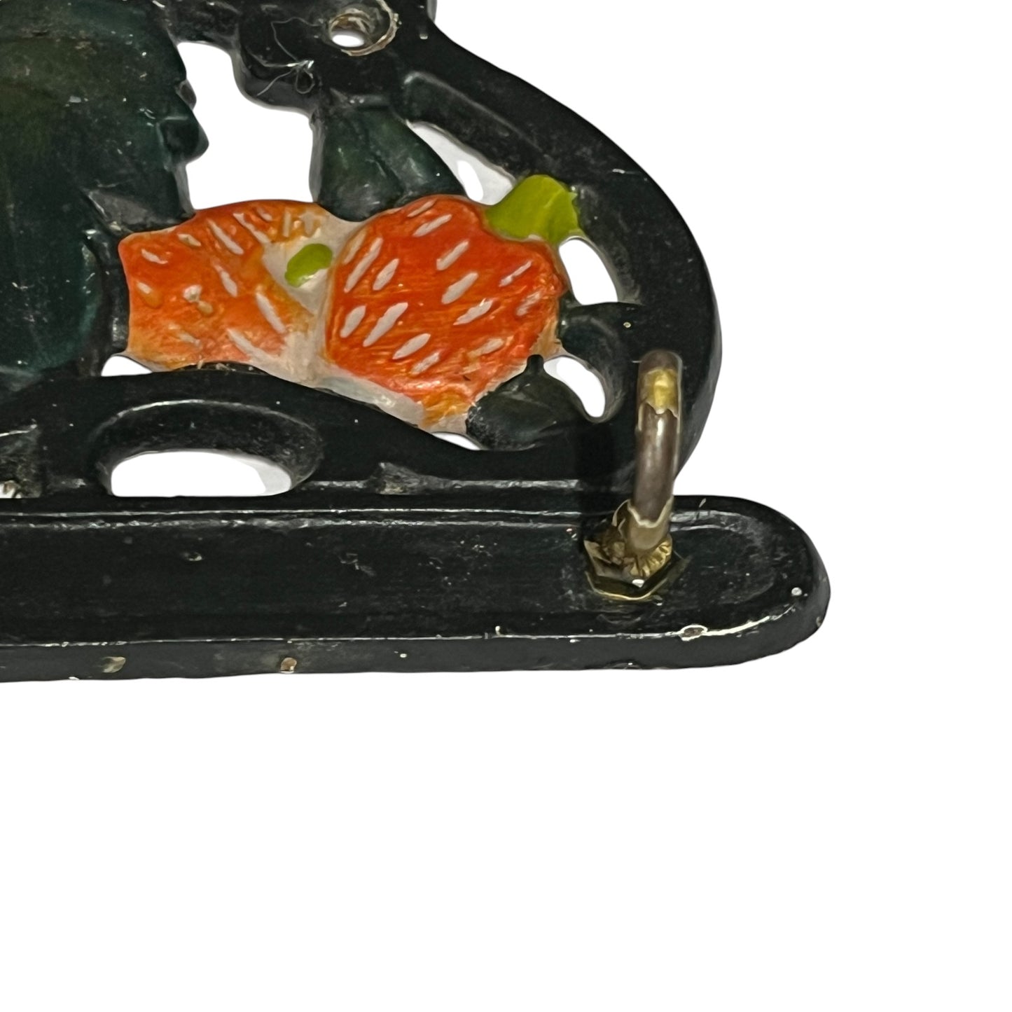 Close-up of a vintage hook set or decorative piece featuring orange and green strawberry motifs, shown against a plain white background