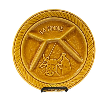 Decorative fondue plate with 'La Fondue' branding on a white background