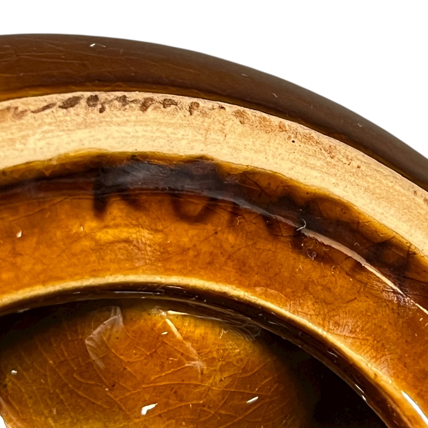 close up of a ceramic plate showing the lettering Korea on a white background 