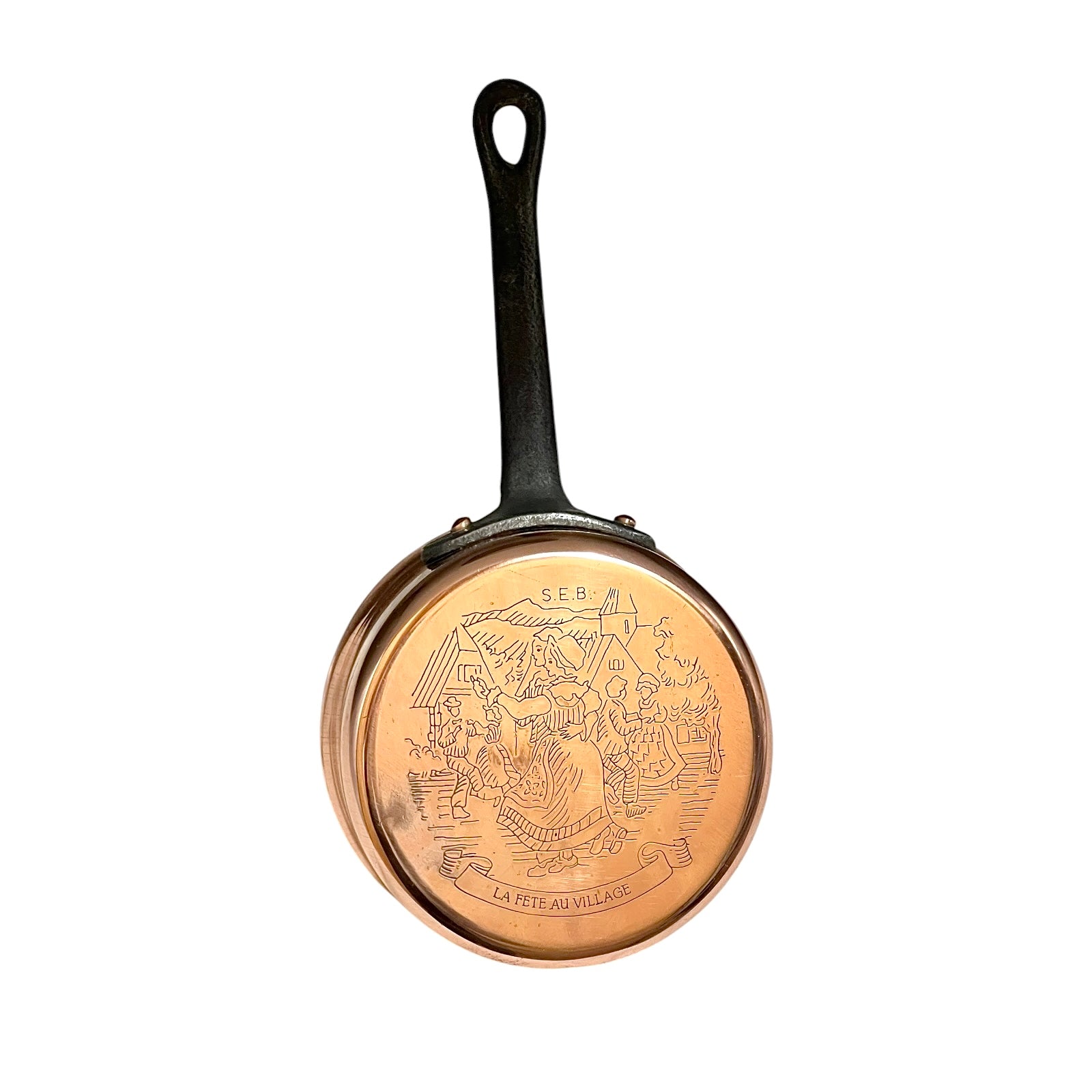 Small copper saucepan with an engraved pattern and a black handle on a white background