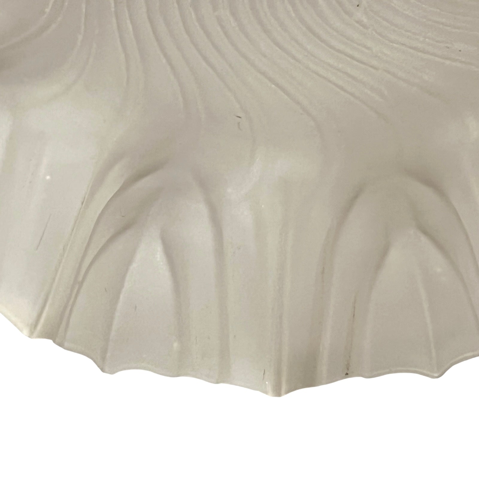 Close up of a glass lampshade and brass fittings on a white background
