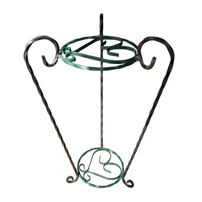 Green and black wrought iron jardinière scrolled plant stand on a white background