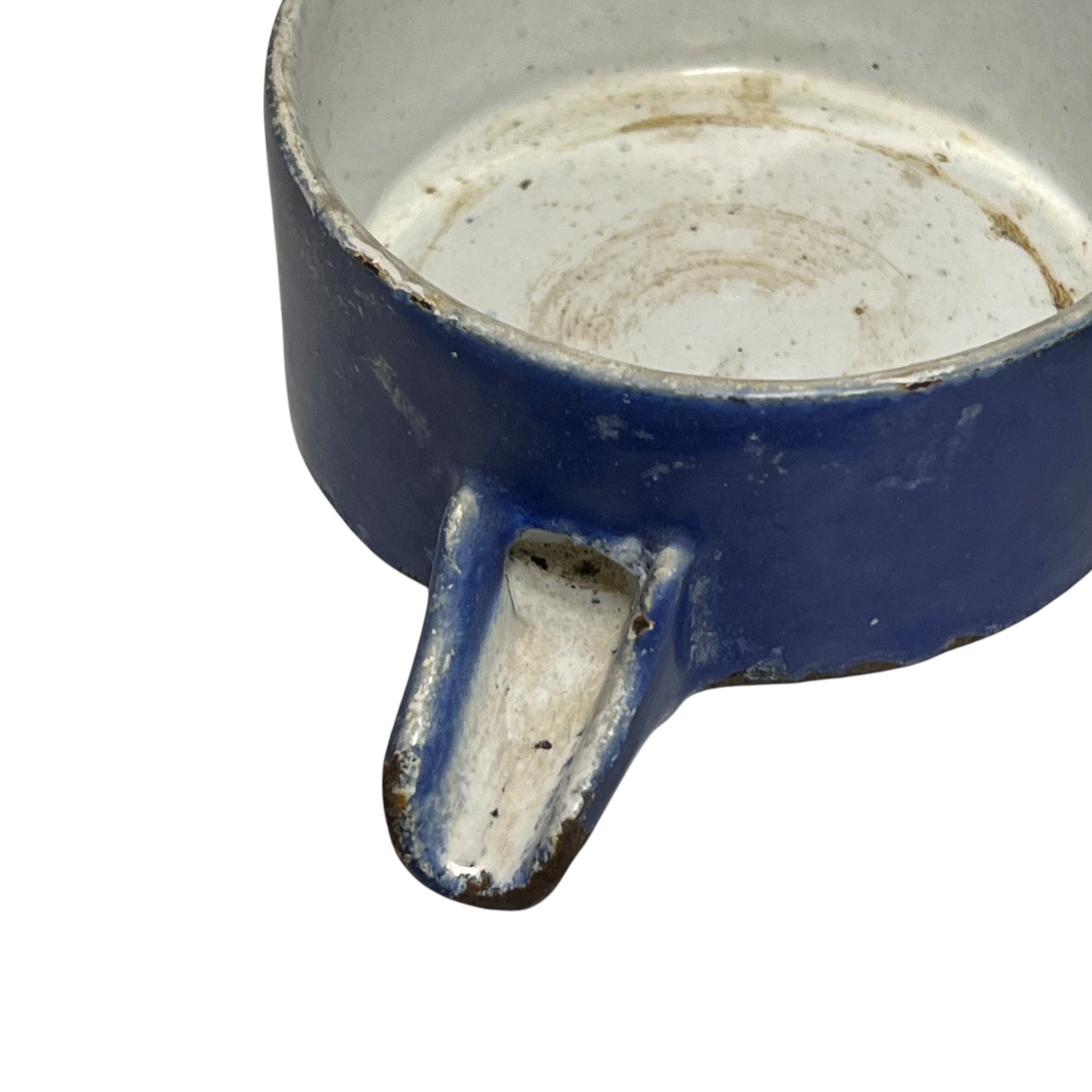 Close-up of a vintage fruit press with a blue pot on a white background