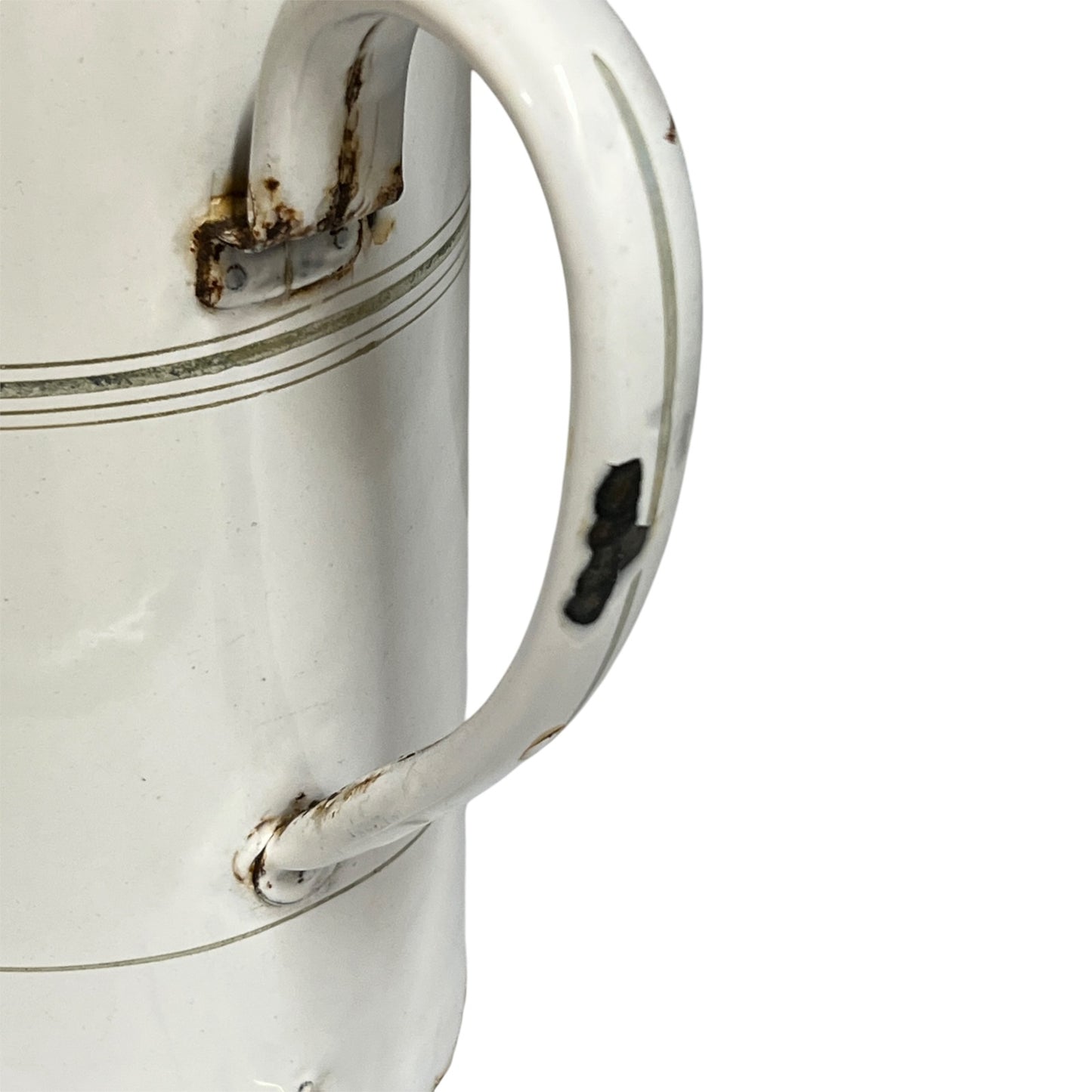 A close-up of a white enamel pot with a curved handle, showing some wear, rust, and a black mark on the handle, set against a plain white background.