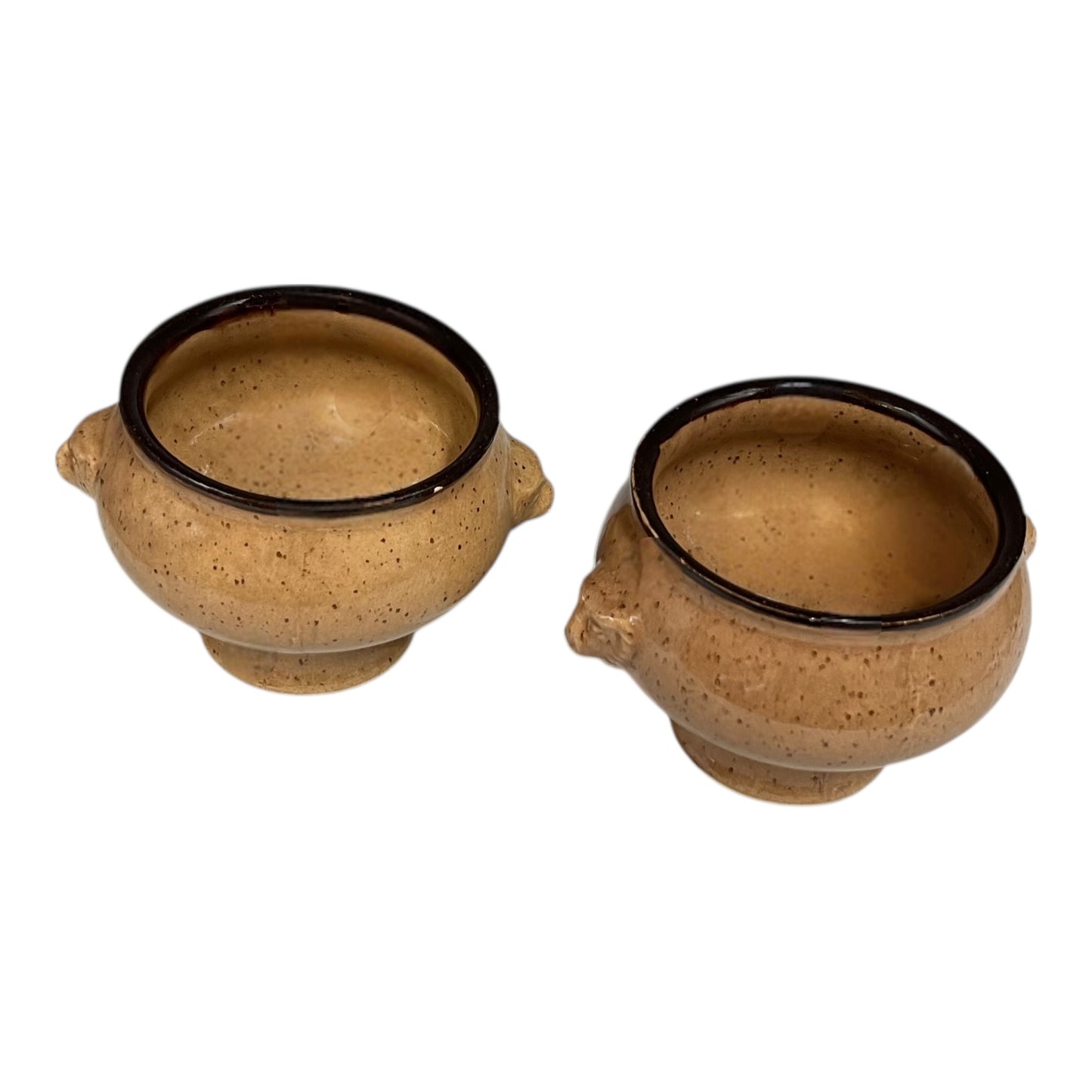 Two French soup bowls with lions head handles on a white background