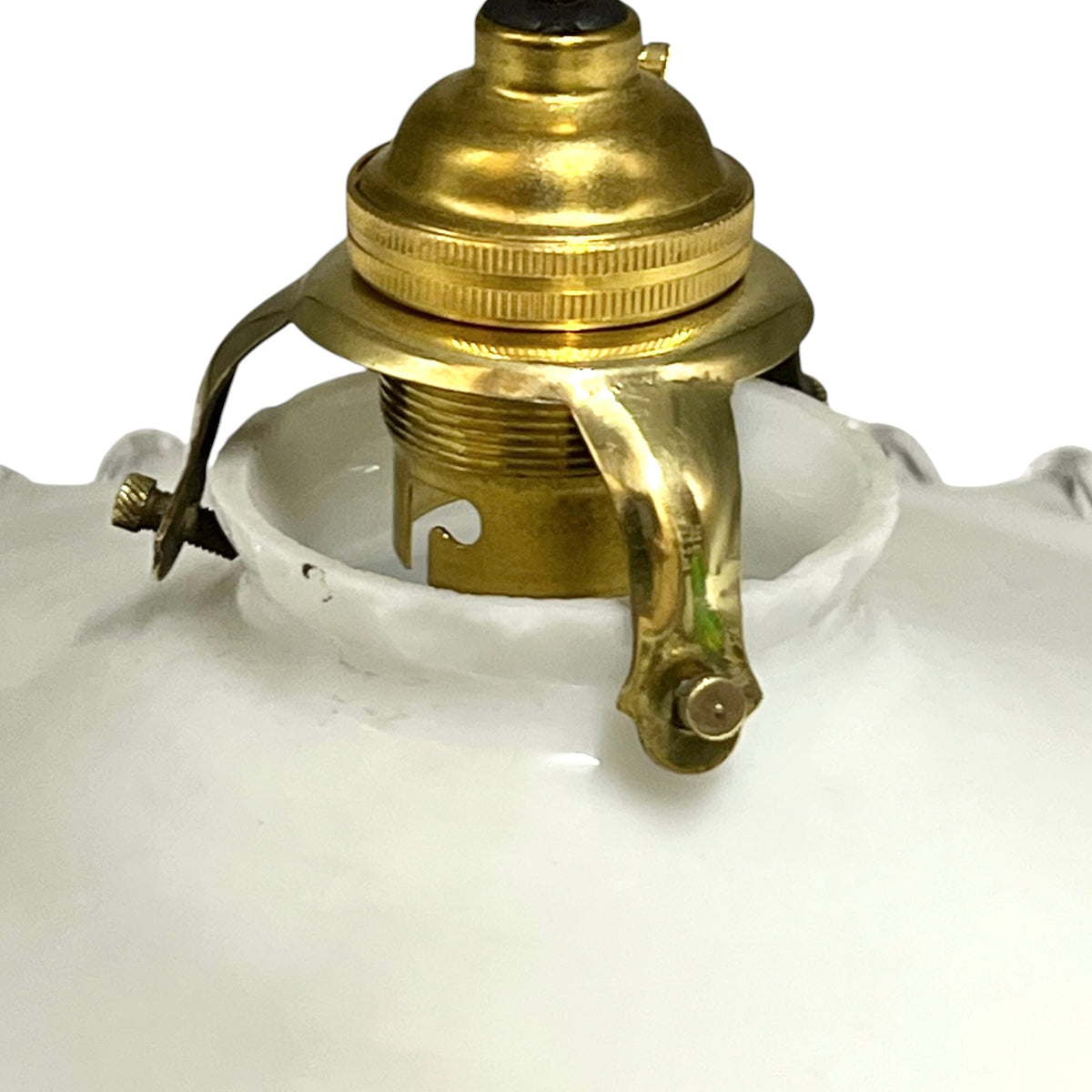 Close-up of a white glass lamp shade with a brass metal socket and hanger assembly visible at the top, on a white background.