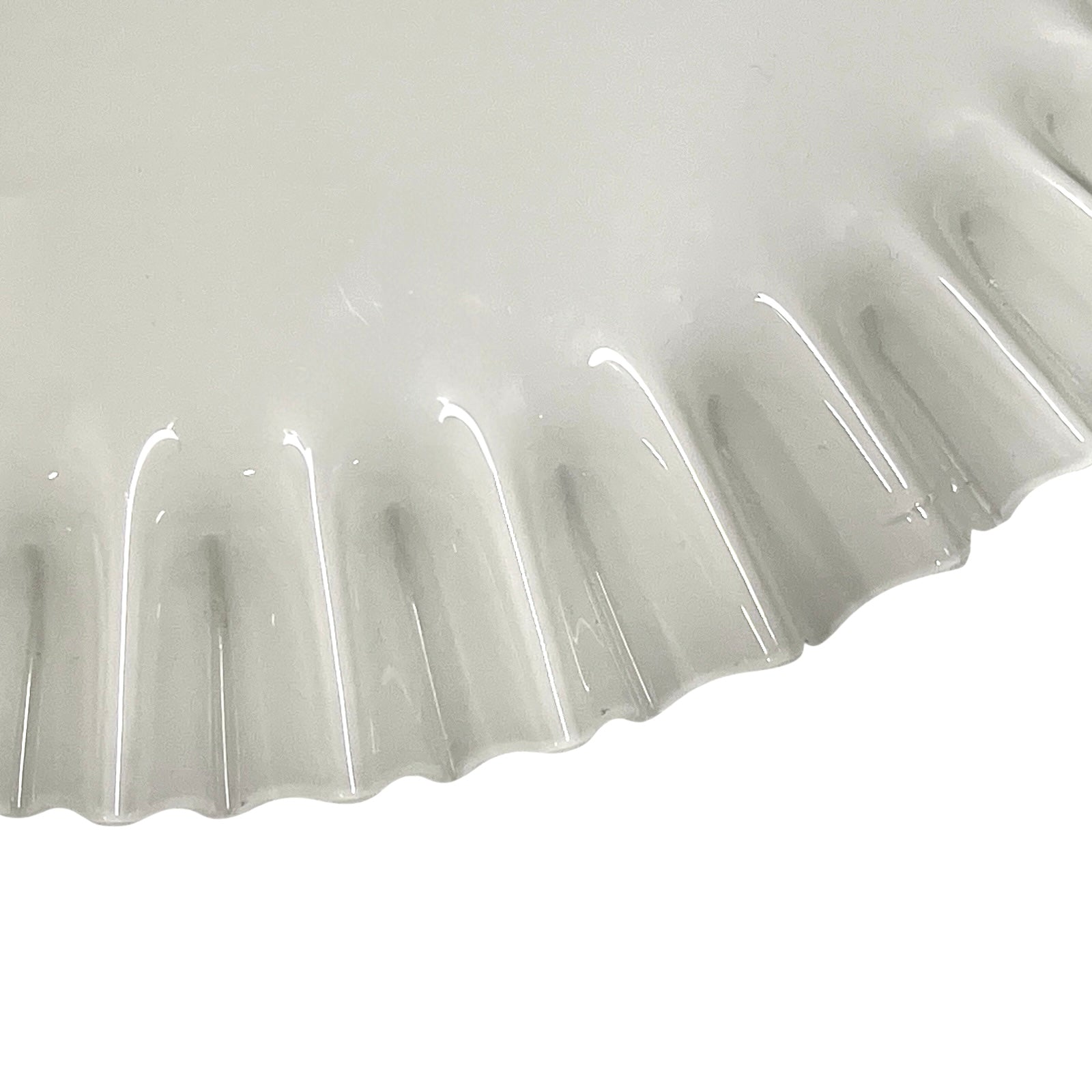 Close-up of a ribbed white glass lampshade on a white background