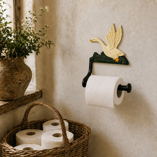 Decorative toilet paper holder shaped like a goose on a wall with a basket of toilet paper below.