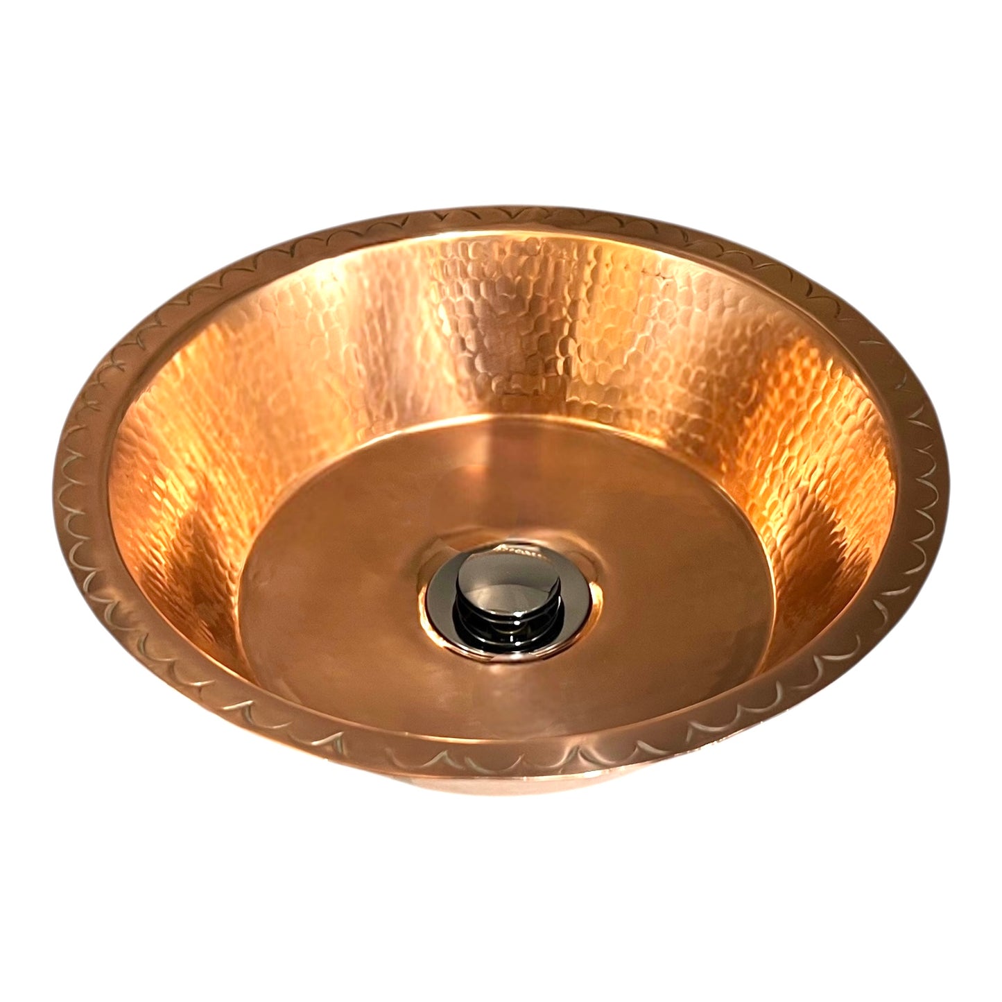 Copper sink with embossed design on a white background