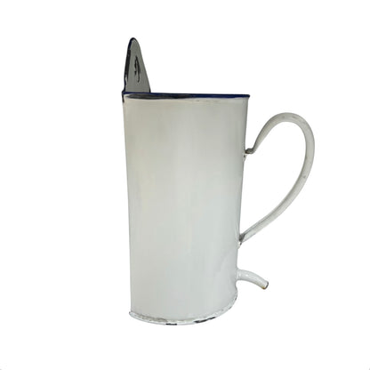 White enamel pitcher with a blue rim on a white background