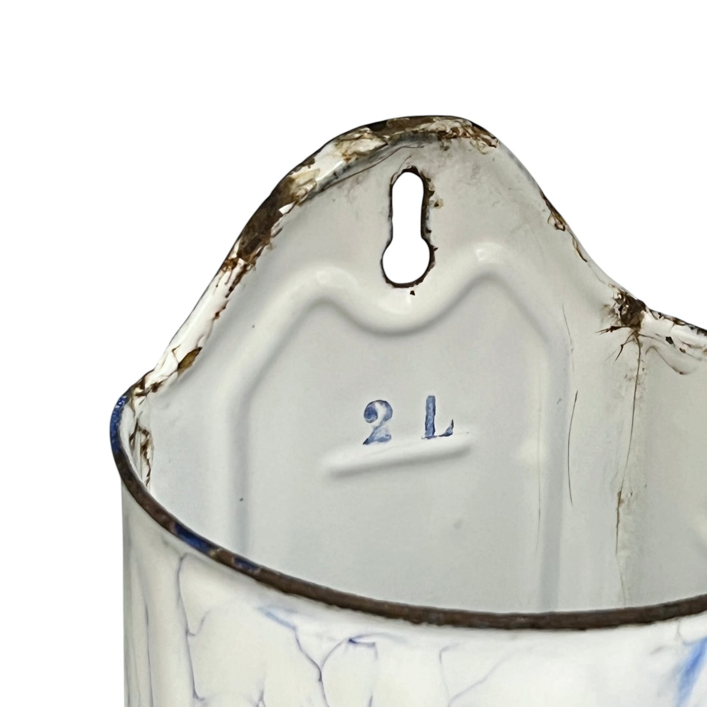 Close-up of the interior of a vintage enamel irrigator, showing a white enamel body with blue crackled detailing, a dark rim, and a keyhole-shaped hanging hole at the top. The size '2 L' is embossed on the inside.