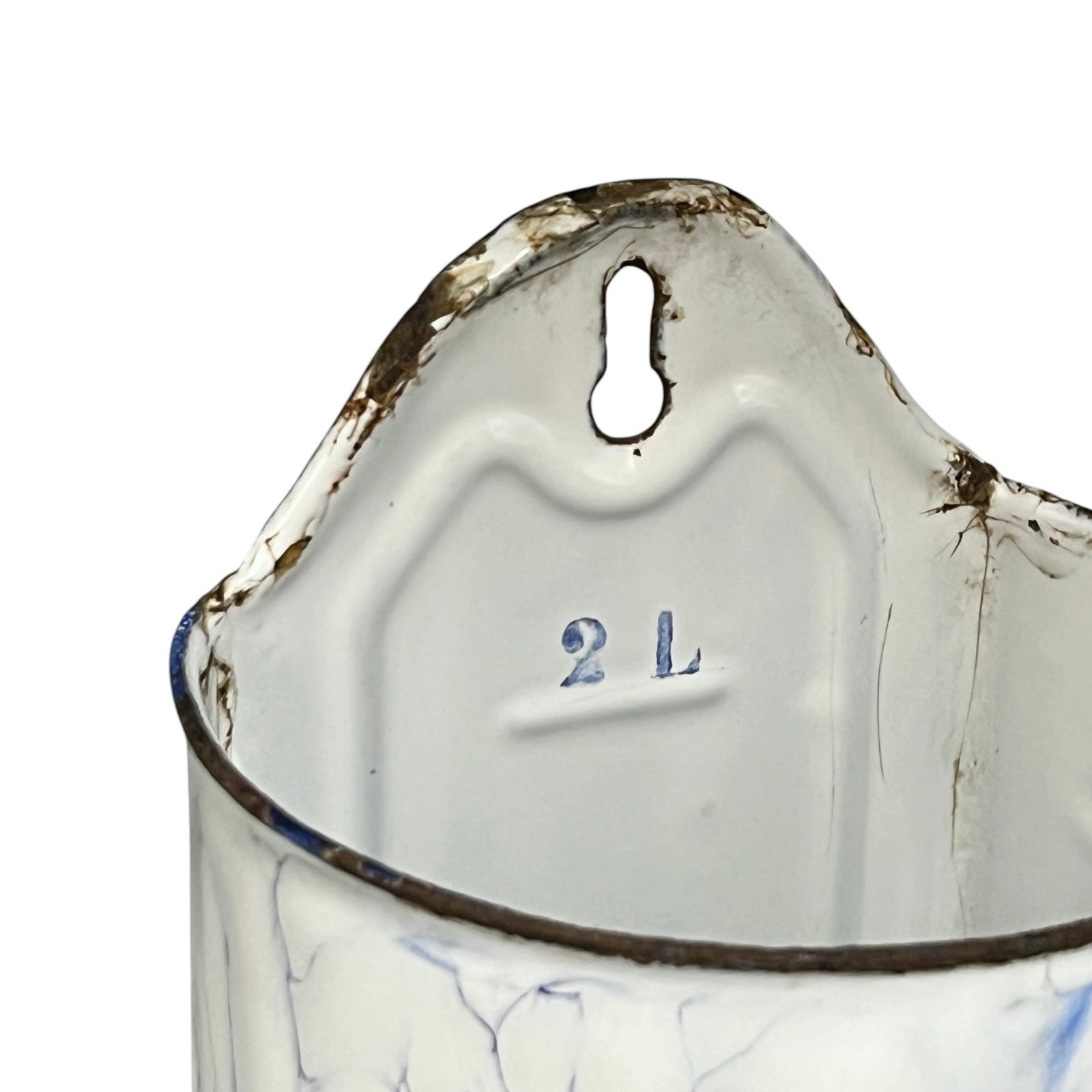 Close-up of the interior of a vintage enamel irrigator, showing a white enamel body with blue crackled detailing, a dark rim, and a keyhole-shaped hanging hole at the top. The size '2 L' is embossed on the inside.