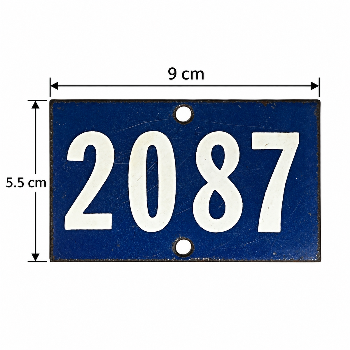 A blue rectangular house number plaque with white numerals '2087' and dimension arrows showing 9 cm width and 5.5 cm height on a white background.