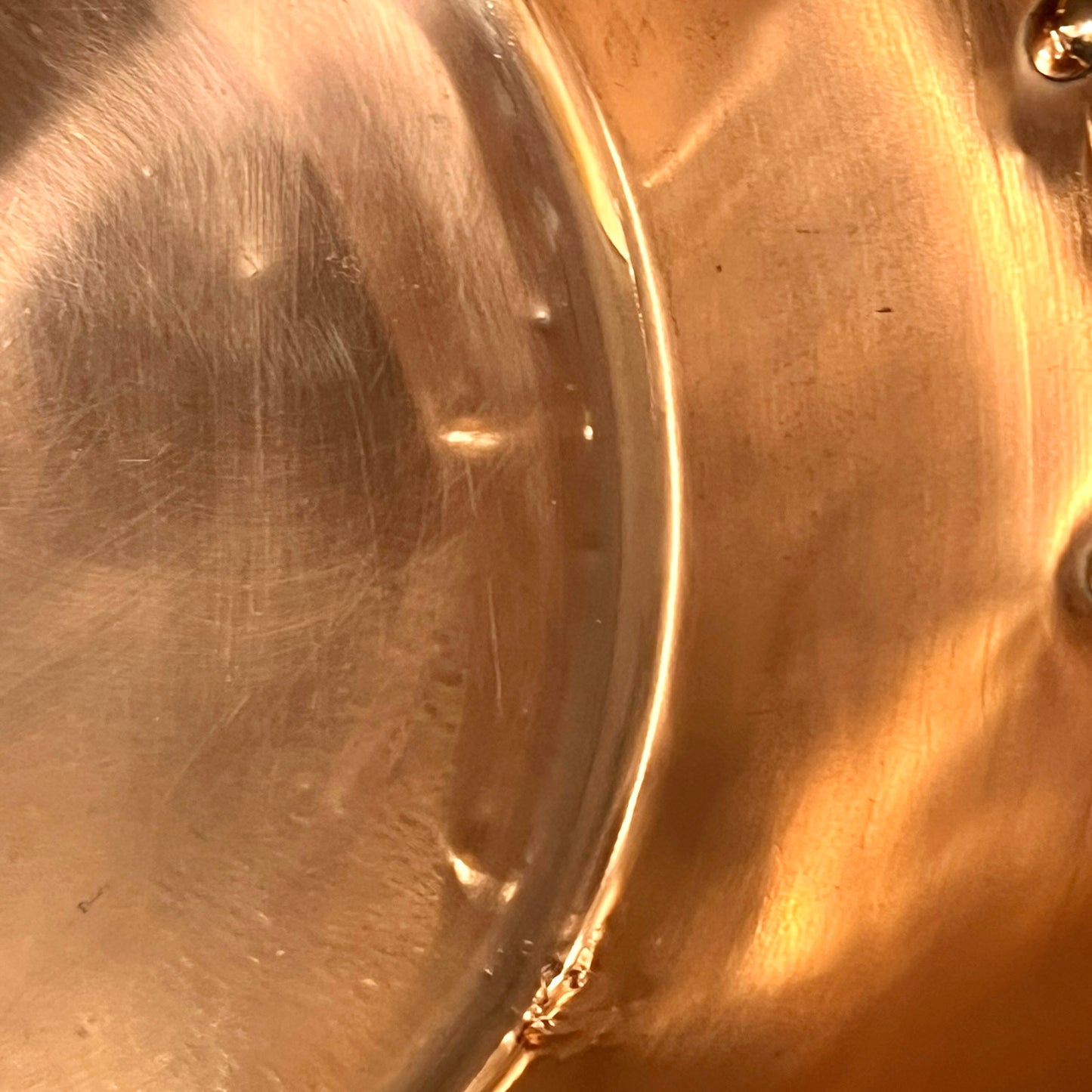 Close-up of a copper sink with a drain plug