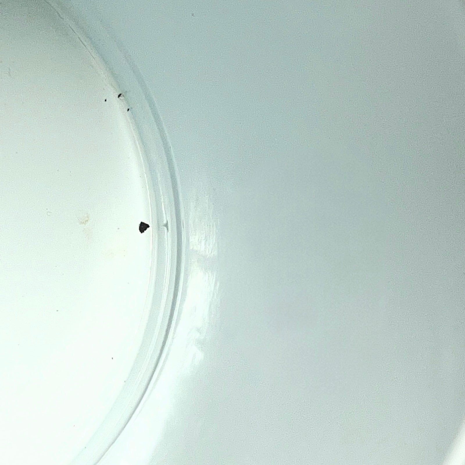 Close up of a red vintage French enamelled coffee pot on a white background