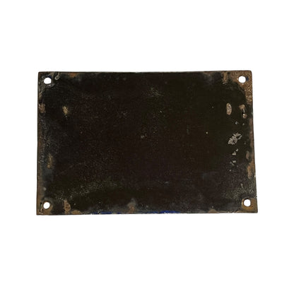 A rectangular dark metal plate with rounded corners and four pre-drilled holes, showing a weathered, distressed black and brown patina on a plain white background.