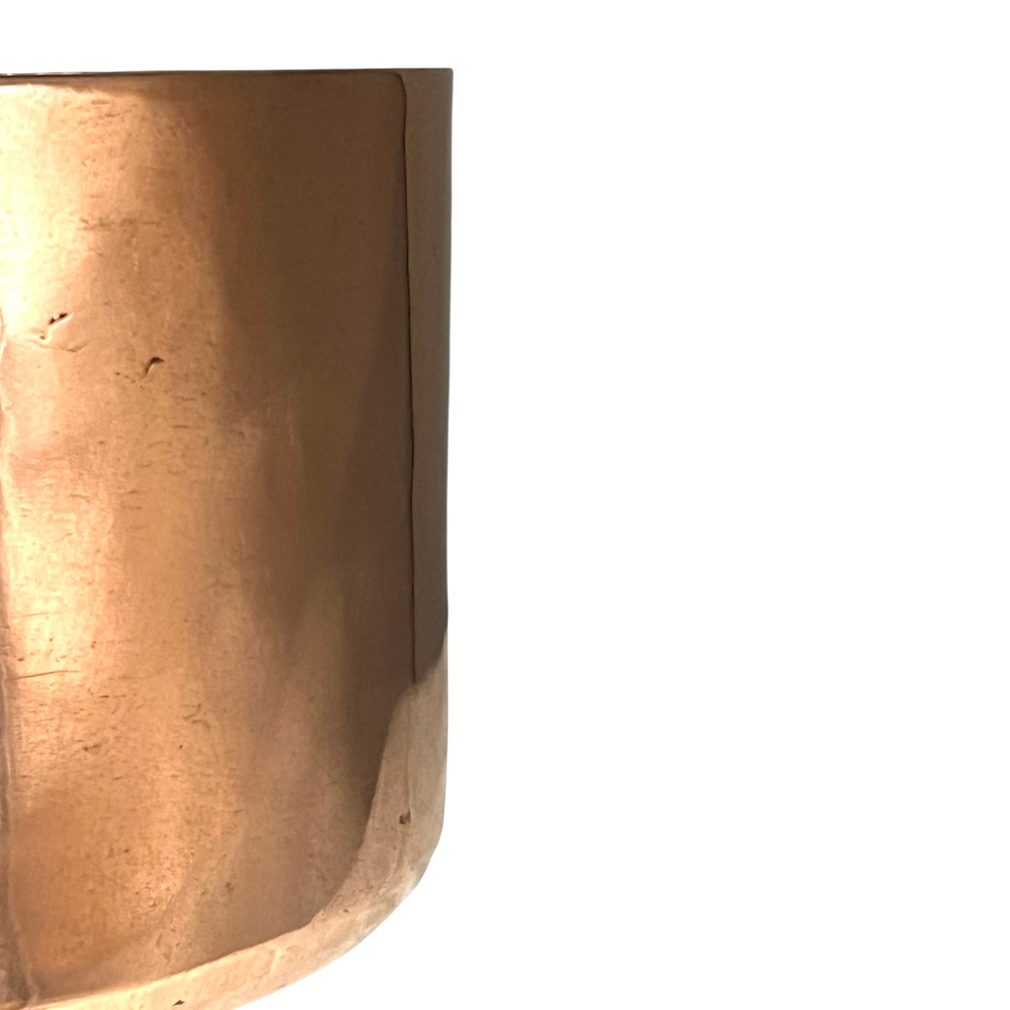 Close-up of a copper pot with a pouring spout on a white background