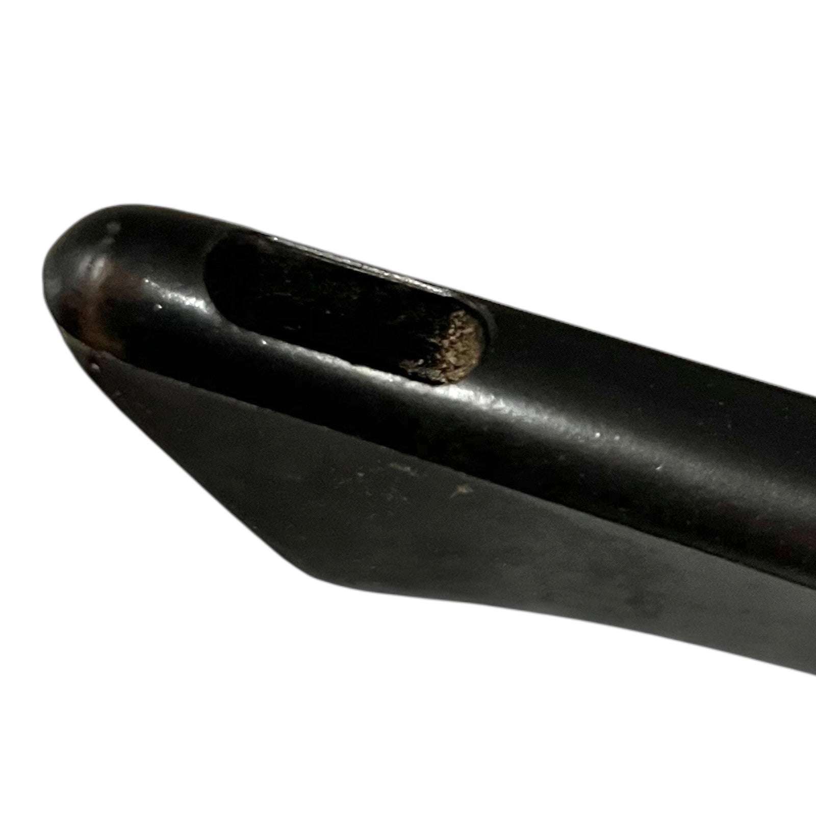 Close-up of a black handle of a frying pan on a white background