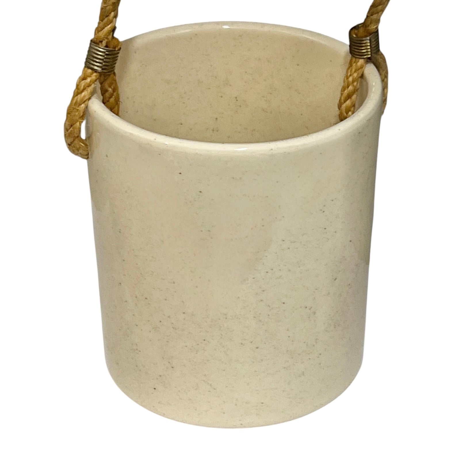 A cylindrical ceramic utensil pot in a speckled cream-beige glaze, featuring a natural jute rope hanging loop with brass wire wraps on the sides, shown against a plain white background.