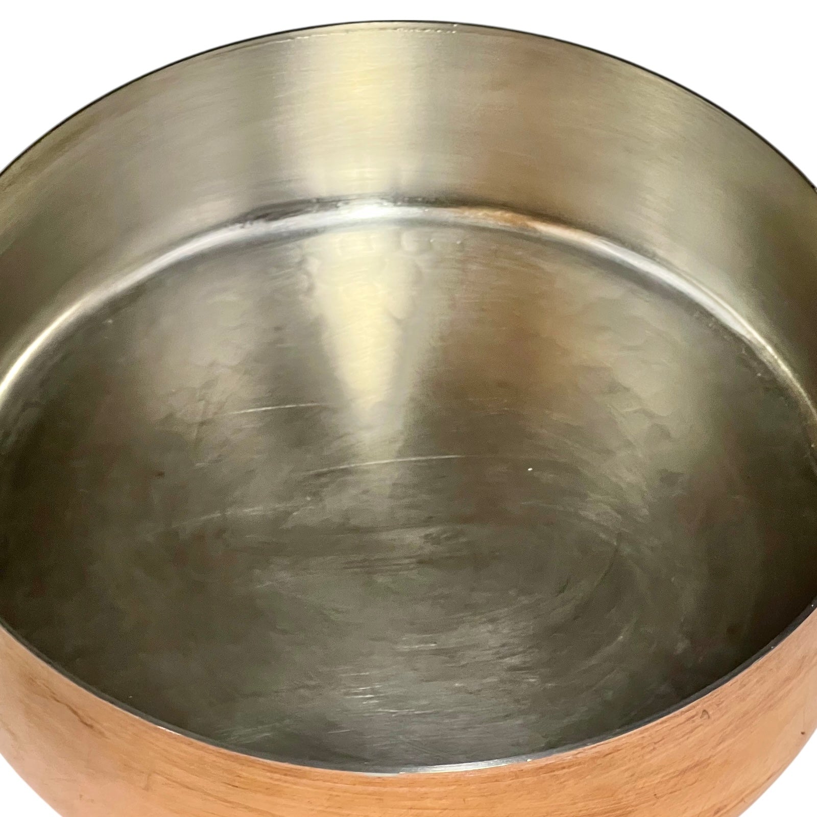 tin lined copper pot with brass handle on a white background