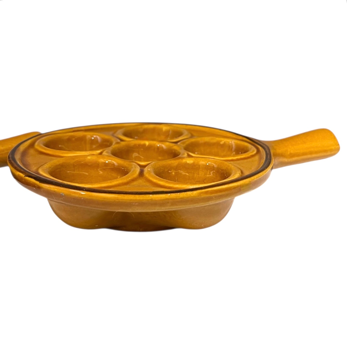 pair of amber-coloured French ceramic escargots plates with handles on a white background