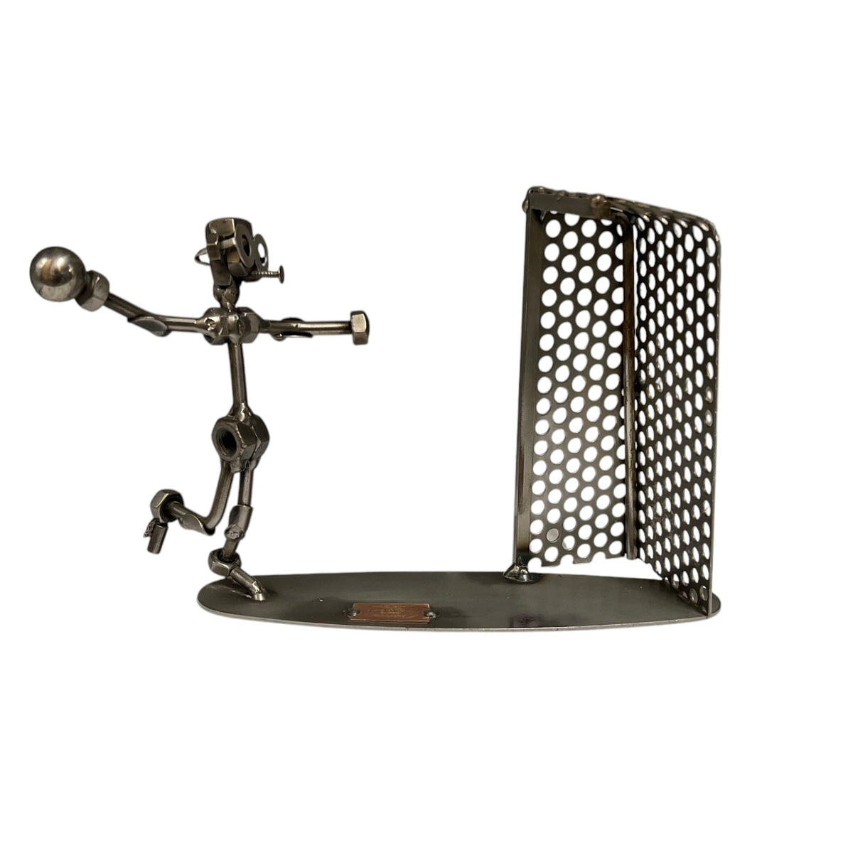 Metal figure made from bits and bolts throwing a ball into a net 