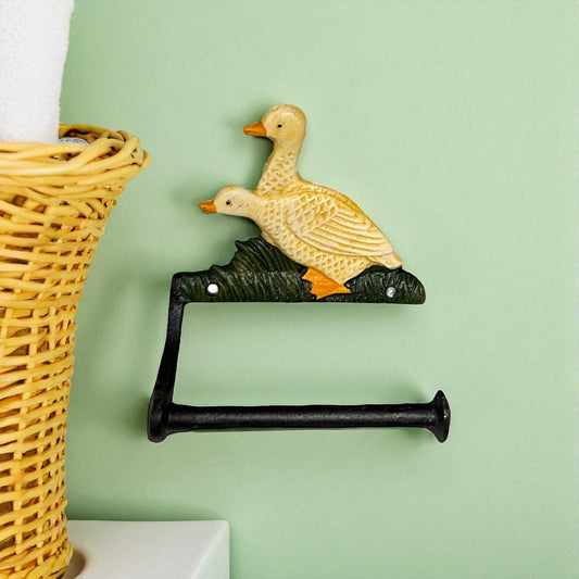 French farmhouse style goose cast iron toilet roll holder on a green wall with a bathroom in the  background