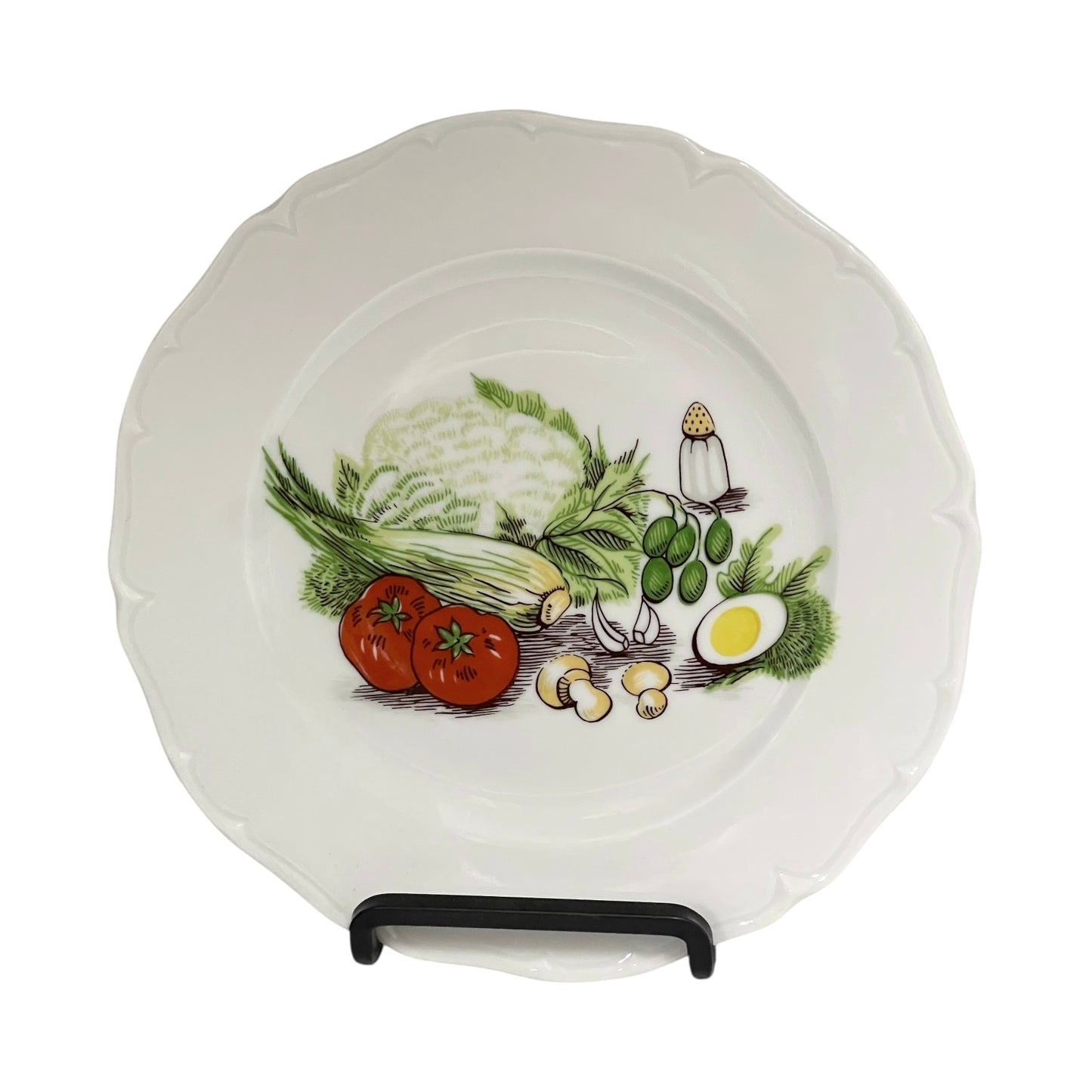 Porcelain plate with decorative salad vegetable illustrations on a white background